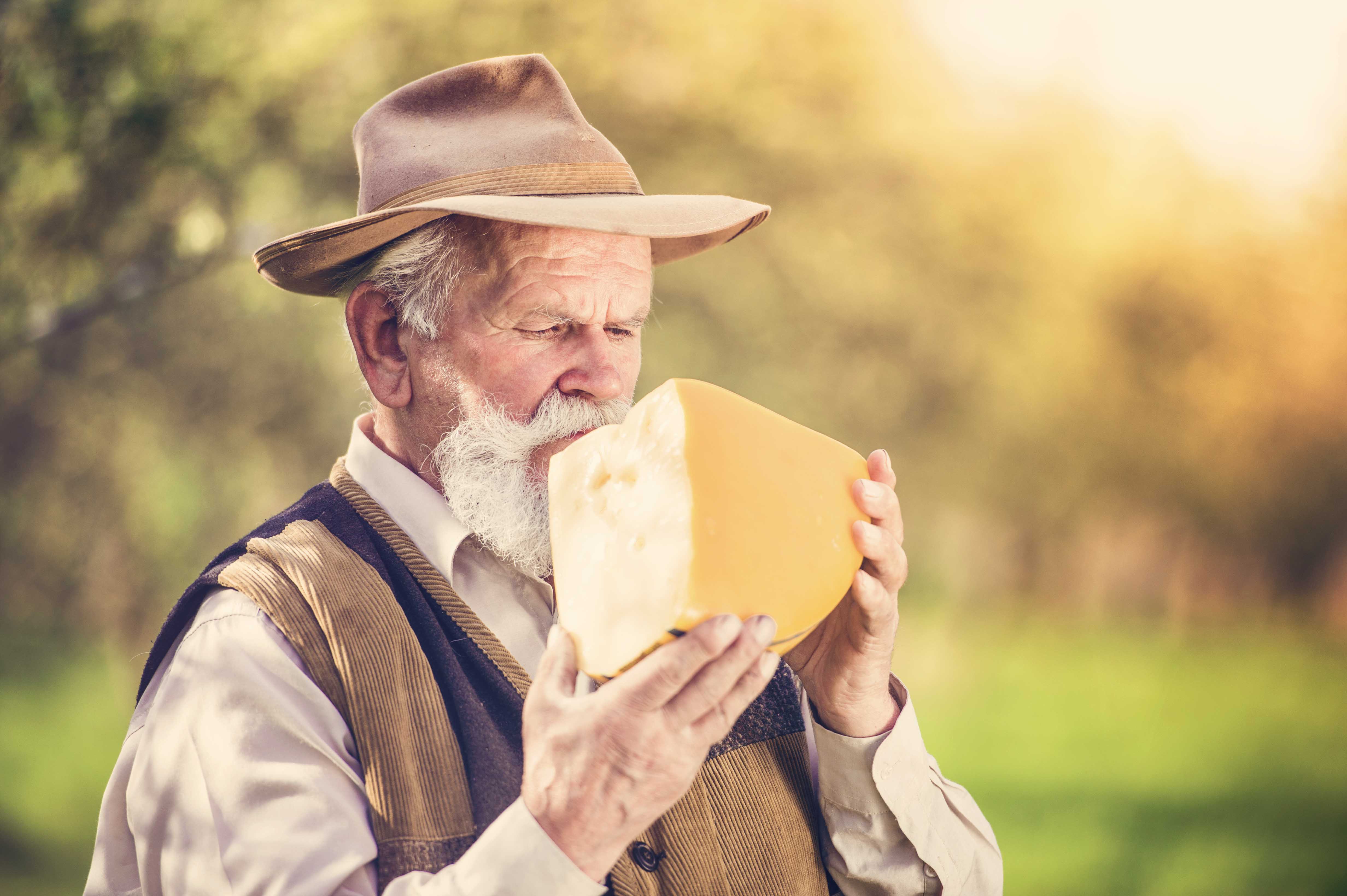 Man eating massive block of cheese