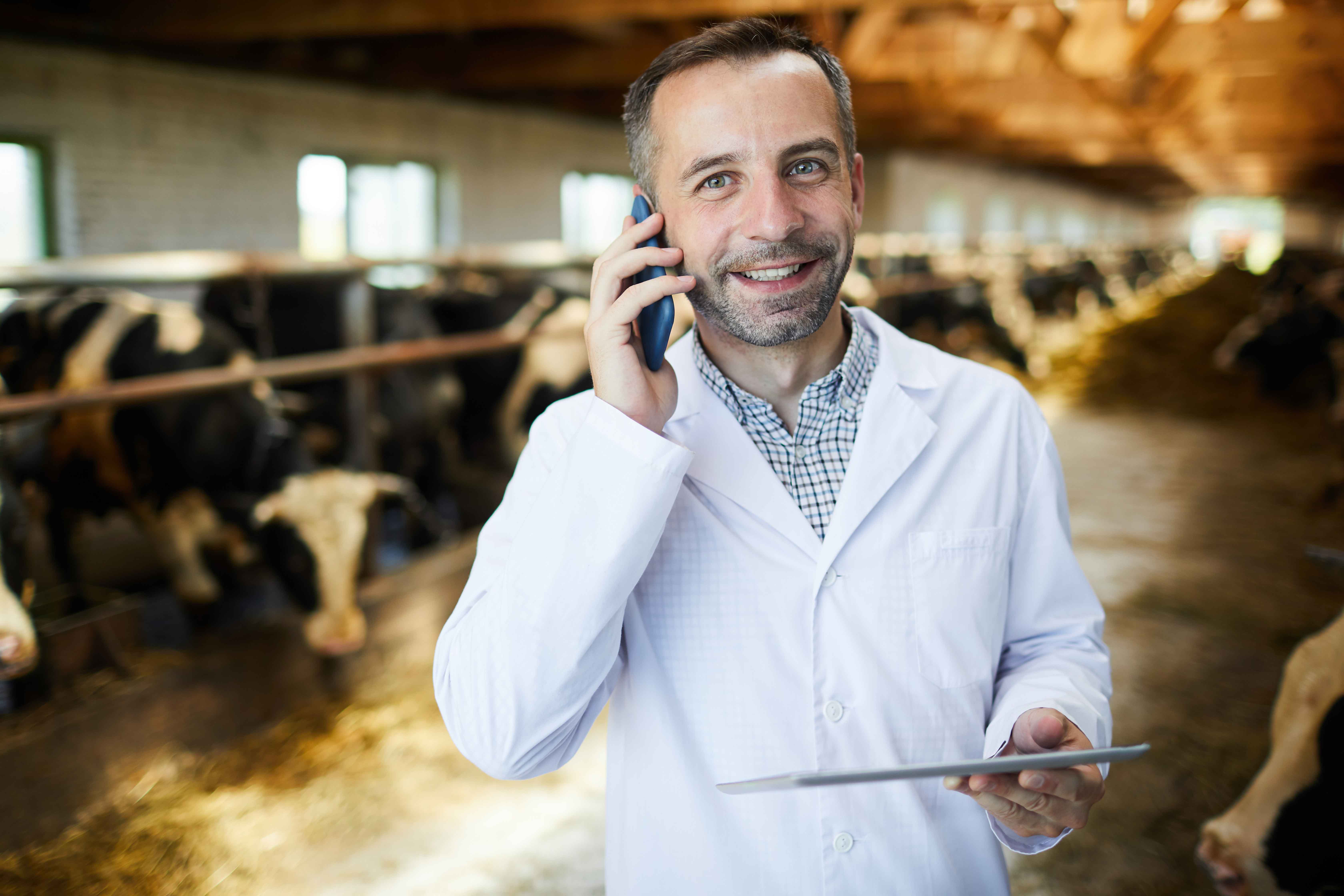 Man on a dairy farm using Milk Moovement software